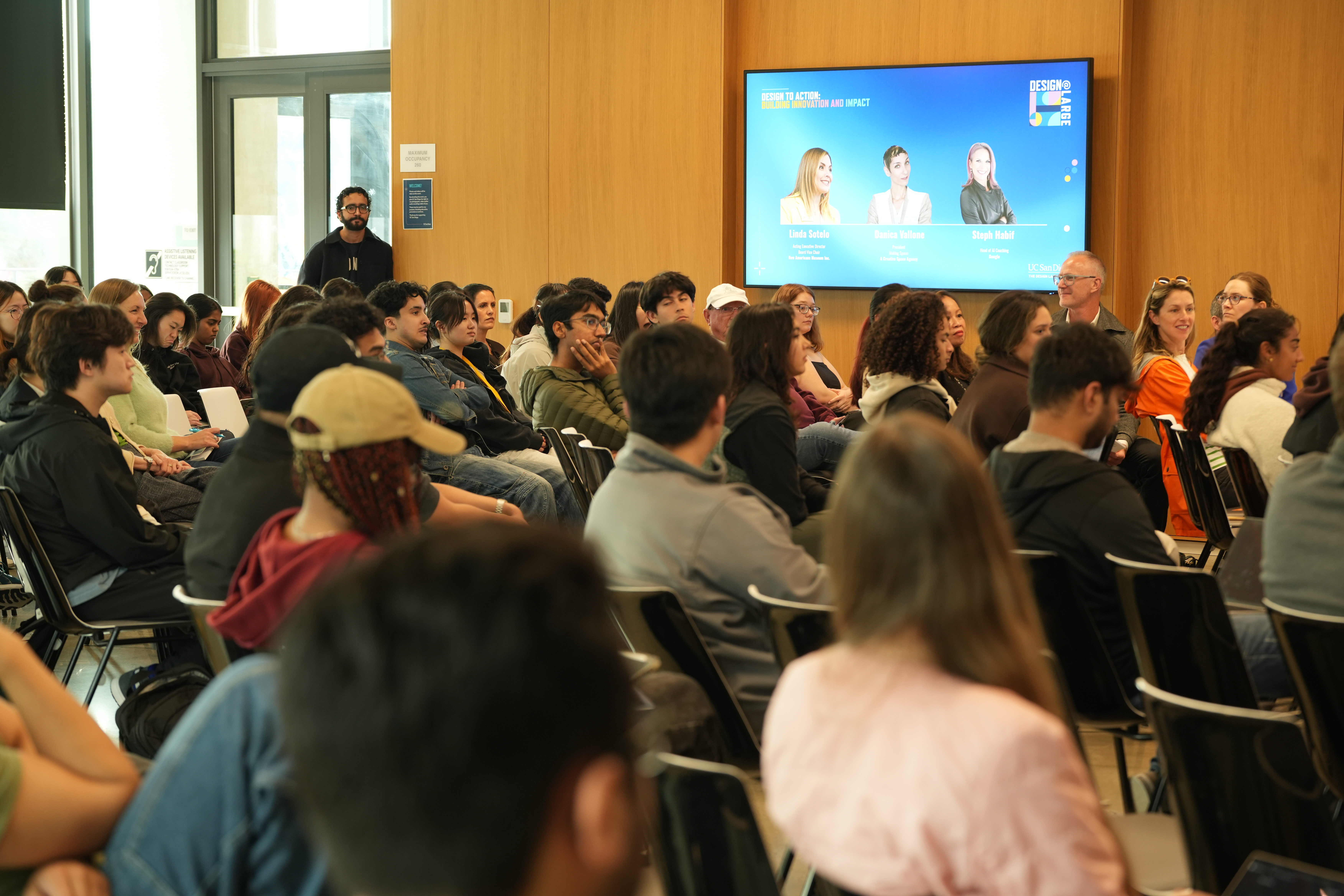 Seated audience watching Design at Large speaker series