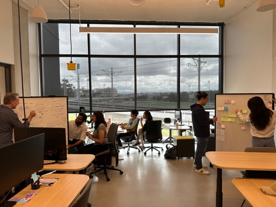 A group of designers collaborate in the Design Lab’s shared space of the Design and Innovation building.